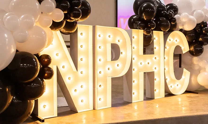 NPHC letters with lights and balloons